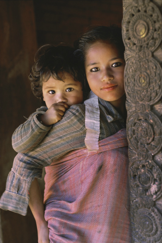 11 Sisters in Bhaktapur, Nepal. With babies strapped to their backs, and an average of seven children per family, the older girls seem to skip childhood right into womanhood.