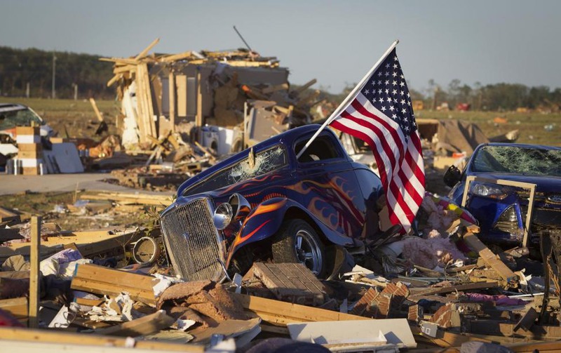 6 Carlo Allegri. A U.S. flag sticks out the window of a damaged hot rod car in a suburban area after a tornado near Vilonia, Arkansas, April 28, 2014