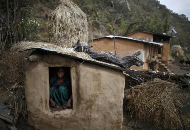 12 Navesh Chitrakar. Uttara Saud, 14, sits inside a Chaupadi shed in the hills of Legudsen village in Achham District in western Nepal, February 16, 2014.