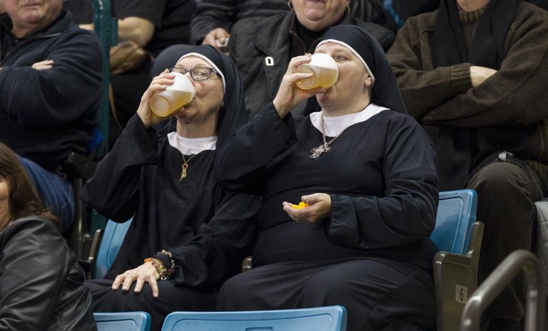 19 Ben Nelms. Two women wearing nun outfits drink beer while watching the 2014 Tim Hortons Brier curling championships in Kamloops, British Columbia, March 8, 2014.