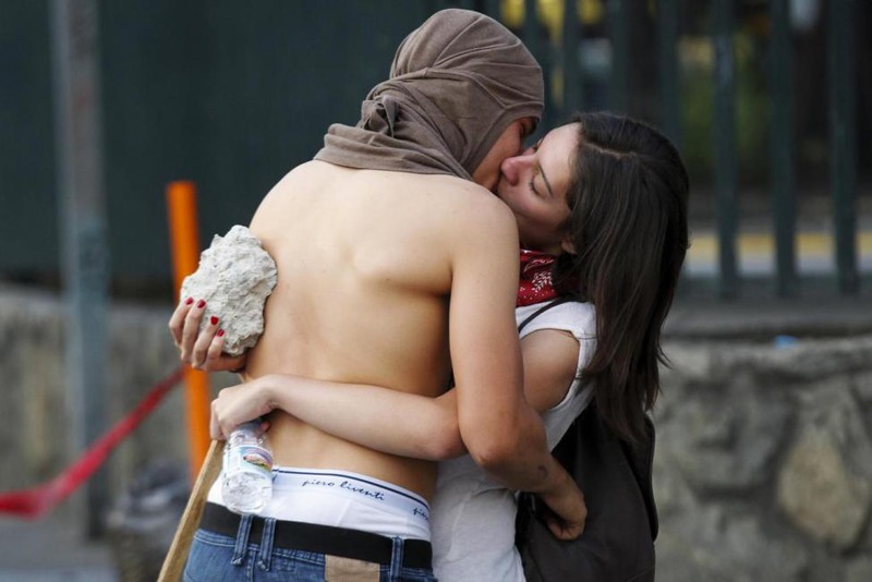 20 Christian Veron. Anti-government protesters kiss during a protest against Venezuela's President Nicolas Maduro's government in Caracas, March 22, 2014.
