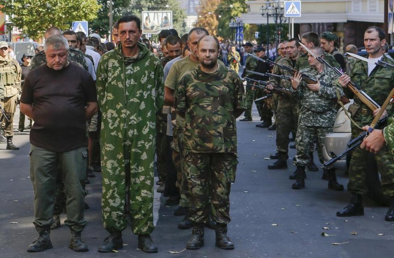 24 Maxim Shemetov. Armed pro-Russian separatists (R) escort a column of Ukrainian prisoners of war as they walk across central Donetsk, August 24, 2014.