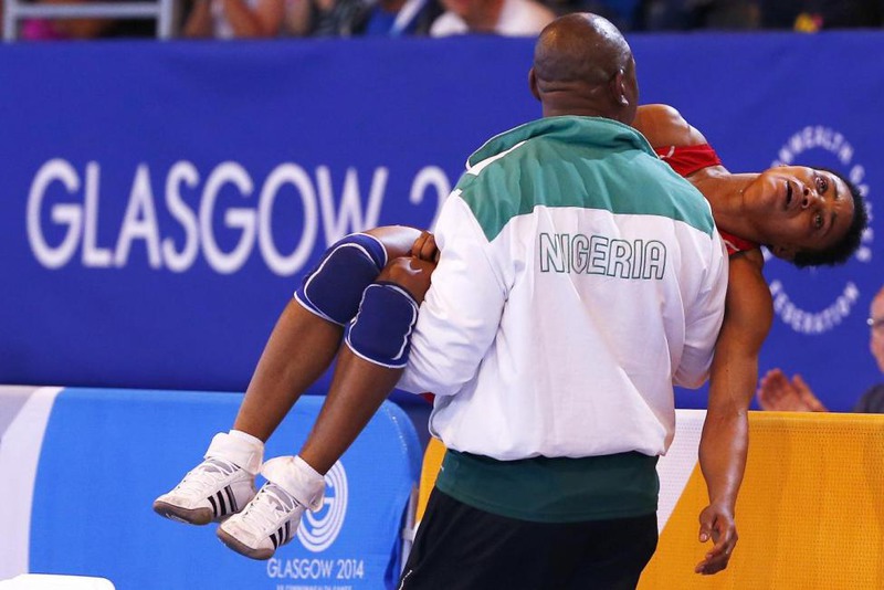 25 Andrew Winning. Ifeoma Nwoye of Nigeria is carried away by her coach after she lost her women's freestyle 55kg wrestling semi-final at the 2014 Commonwealth Games in Glasgow, Scotland, July 31, 2014.