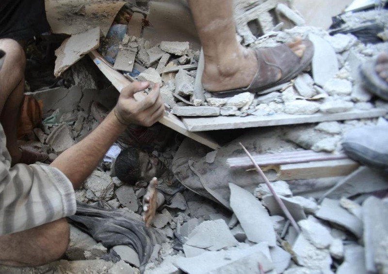30 Ibraheem Abu Mustafa. Palestinians rescue Mahmoud al-Ghol from under the rubble of a house in Rafah in the southern Gaza Strip, August 3, 2014.