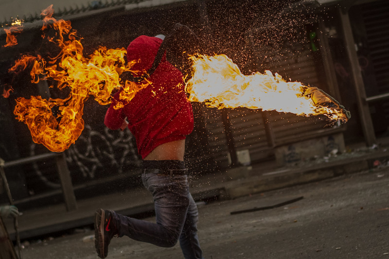 11 A protester hurled a Molotov cocktail during clashes with the police. The antigovernment demonstrations had been going on for two months.
Meridith Kohut for The New York Times. CARACAS, VENEZUELA
04/17/2014