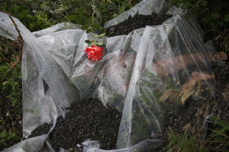 22 A plastic sheet covered a passenger of Malaysia Airlines Flight 17, which was shot down over Ukraine.
Maxim Zmeyev/Reuters. NEAR ROZSYPNE, UKRAINE
07/18/2014