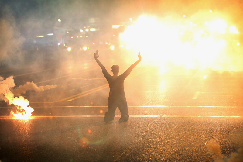 29 Tear gas enveloped a protester as violent clashes with the police continued after the shooting death of Michael Brown.
Scott Olson/Getty Images. FERGUSON, MO.
08/17/2014