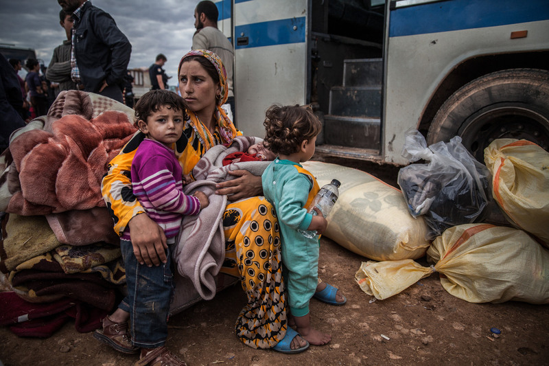 37 A Syrian Kurdish mother and her children waited to be taken to a Turkish shelter after fleeing shelling from Islamic State forces.
Bryan Denton for The New York Times. YUMURTALIK, TURKEY
09/29/2014