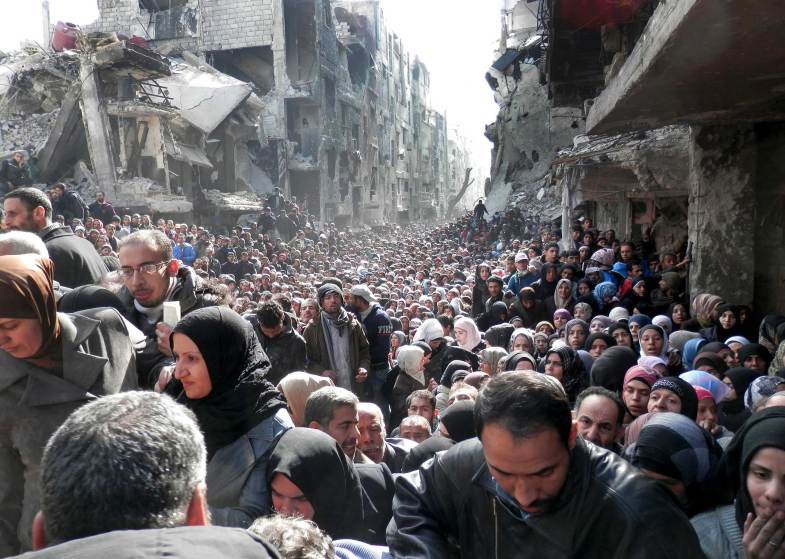24  Автор - UNITED NATIONS RELIEF AND WORKS—REUTERS. A handout photo of Palestinian refugees waiting for food aid in the Yarmouk camp on the outskirts of Damascus, Syria, Jan. 31, 2014.