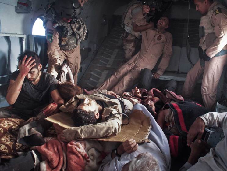 29  Автор - Moises Saman—Magnum for TIME. Survivors of a helicopter crash, including Yazidi refugees and Kurdish and Iraqi Army personnel, onboard a rescue helicopter that transported them from the crash site back to Kurdish-controlled Dohuk Province in the Sinjar Mountains, Iraq, Aug. 12, 2014.