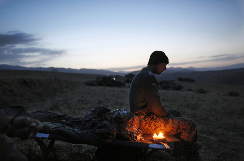 3 A German soldier sits next to candles lit to celebrate his 34th birthday, during a long term patrol in Yaftal e Sofla, in the mountainous region of Feyzabad, east of Kunduz, Afghanistan, on September 16, 2009. (AP Photo/Anja Niedringhaus)