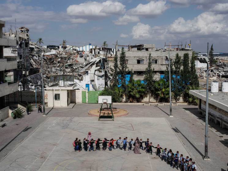 33  Автор - Peter van Agtmael—Magnum. Schoolchildren head to class at the Sobhi Abu Karsh School in the Shujai'iya neighborhood of Gaza, Oct. 20, 2014.