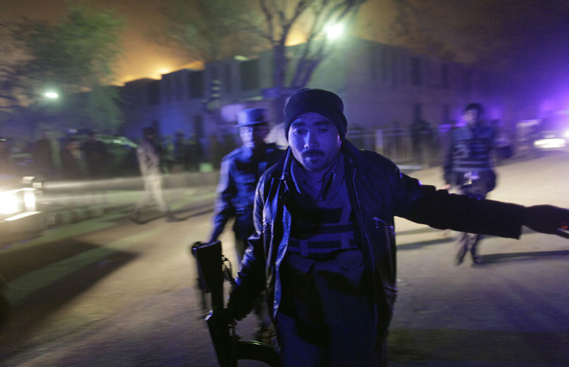 10 An Afghan police officer rushes to the scene where a rocket hit outside the luxury Serena Hotel in Kabul on November 21, 2009. At least two people were injured, the Afghan Interior Ministry said. (AP Photo/Anja Niedringhaus)