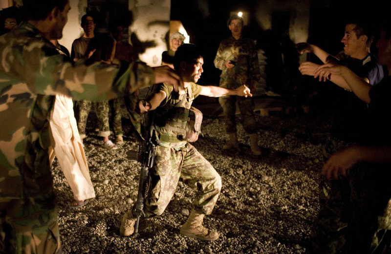 15 Afghan army soldiers dance to celebrate the Eid al-Fitr that marks the end of the holy fasting month of Ramadan at their combat outpost outside Salavat, Panjwaii district, on September 10, 2010. (AP Photo/Anja Niedringhaus)