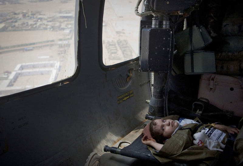 18 Seven year old Afghan girl Persia looks up as she flies onboard a Medevac helicopter from the US Army's Task Force Lift "Dust Off", Charlie Company 1-214 Aviation Regiment to the next military hospital outside Sangin, Helmand Province, on June 7, 2011. Persia received head injuries after falling off a truck and was taken by her father to the next ISAF outpost seeking medical help. (AP Photo/Anja Niedringhaus)