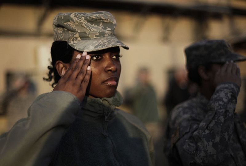 19 American soldiers salute while the national anthem is played during a ceremony marking Veterans Day at the U.S. Camp Eggers in Kabul on November 11, 2009. (AP Photo/Anja Niedringhaus)
