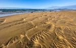 The water draws patterns in the sand