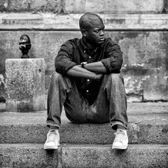 Among the Broken Echoes of Paris, He Sat Watching the Day Fold Into Silence